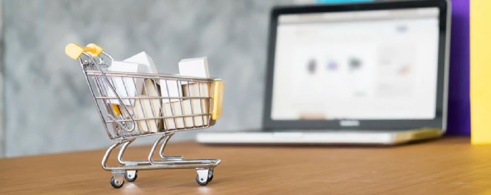 shopping cart in front of computer