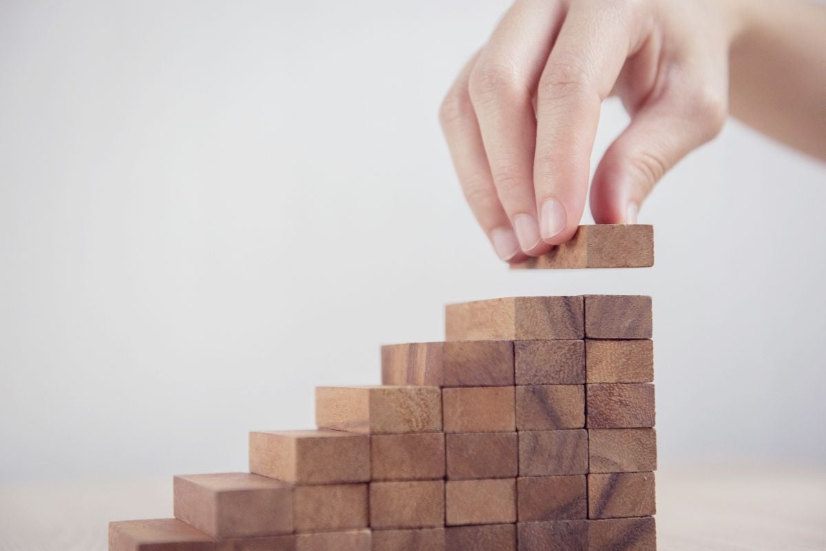 Toy building blocks being built by hand