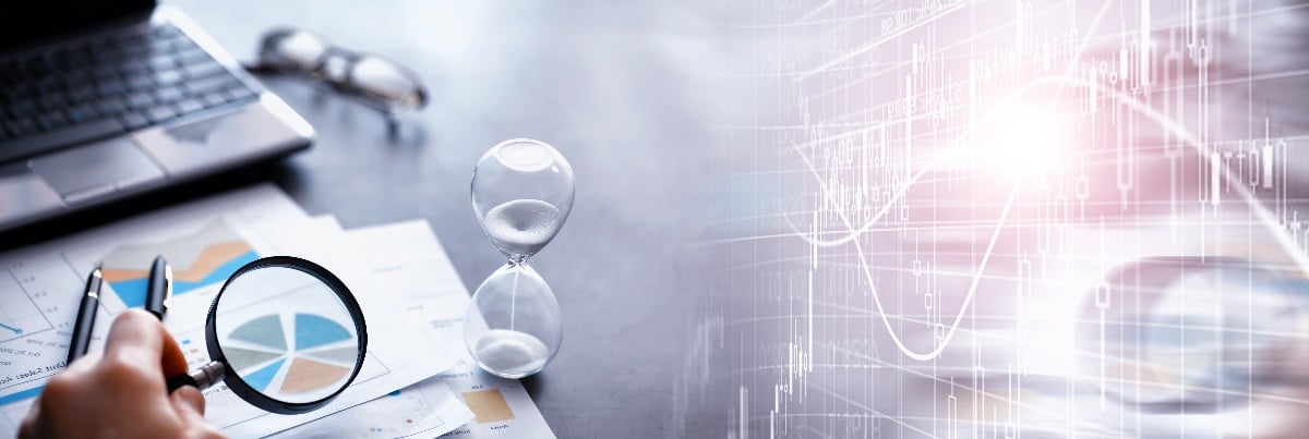 hourglass on paper with magnifying glass