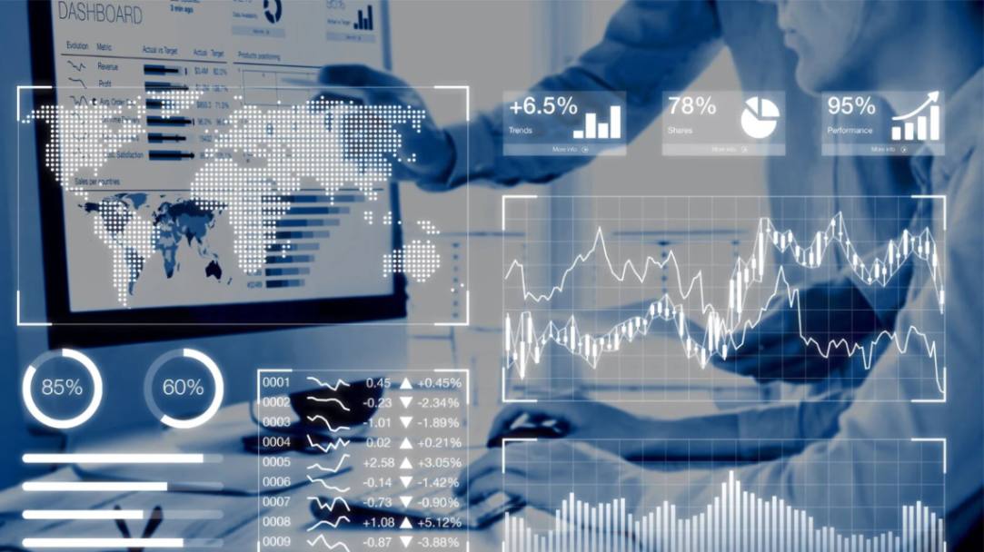 Hands in front of computer pointing to analytics on the screen