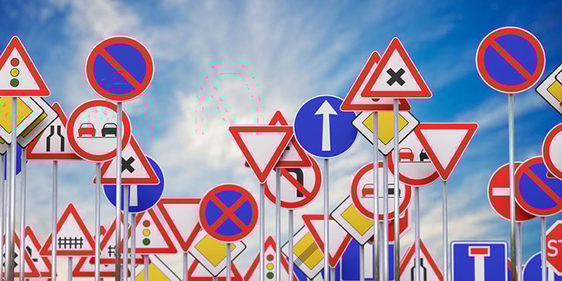 warning signs against the sky