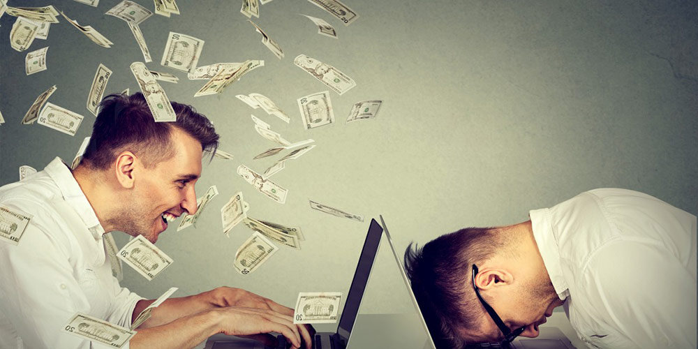 Fraudster making making money on one computer and the other is a frustrated marketer putting face into laptop