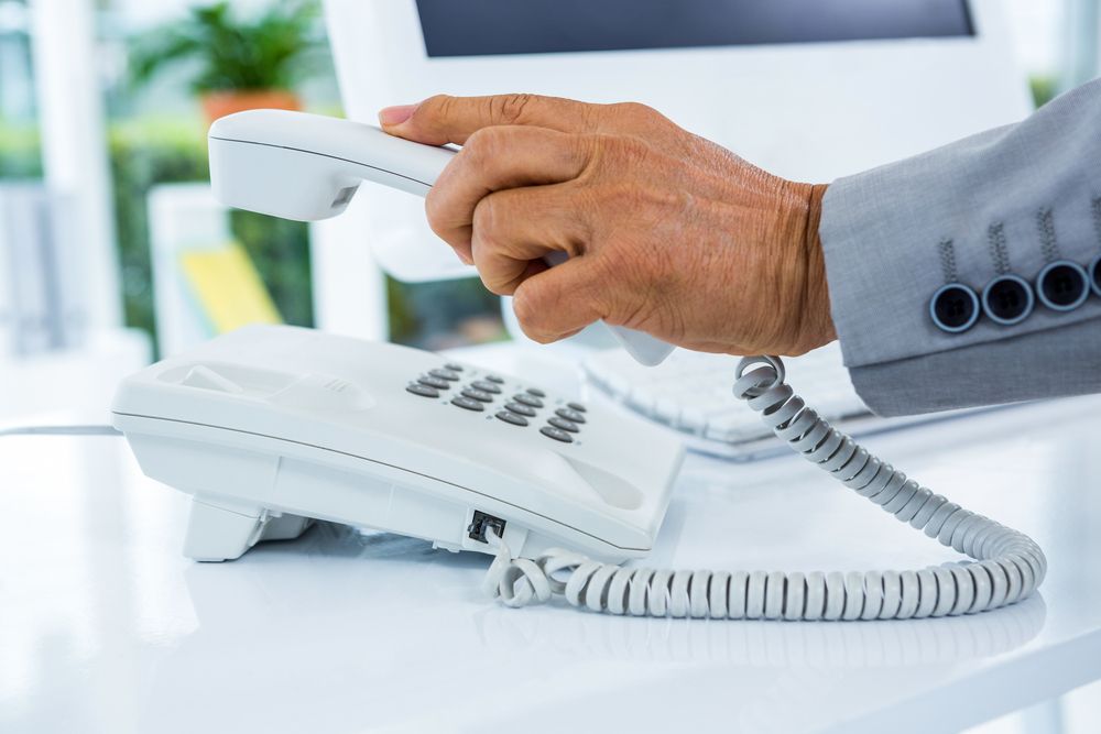 Businessman answering the phone in an office