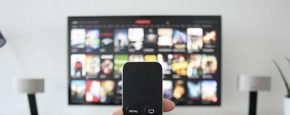 mobile phone being used as a remote control for a tv