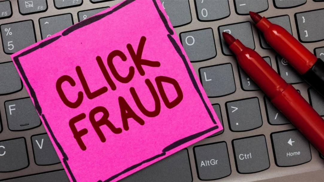 Click fraud written on a sticky note laying on a computer