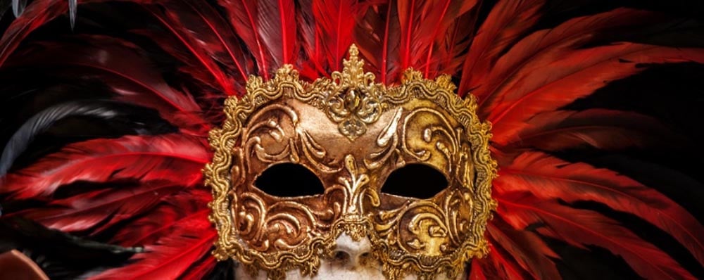 gold mask with red feathers