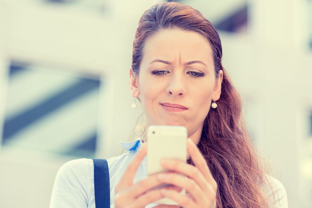 girl angry while looking at phone