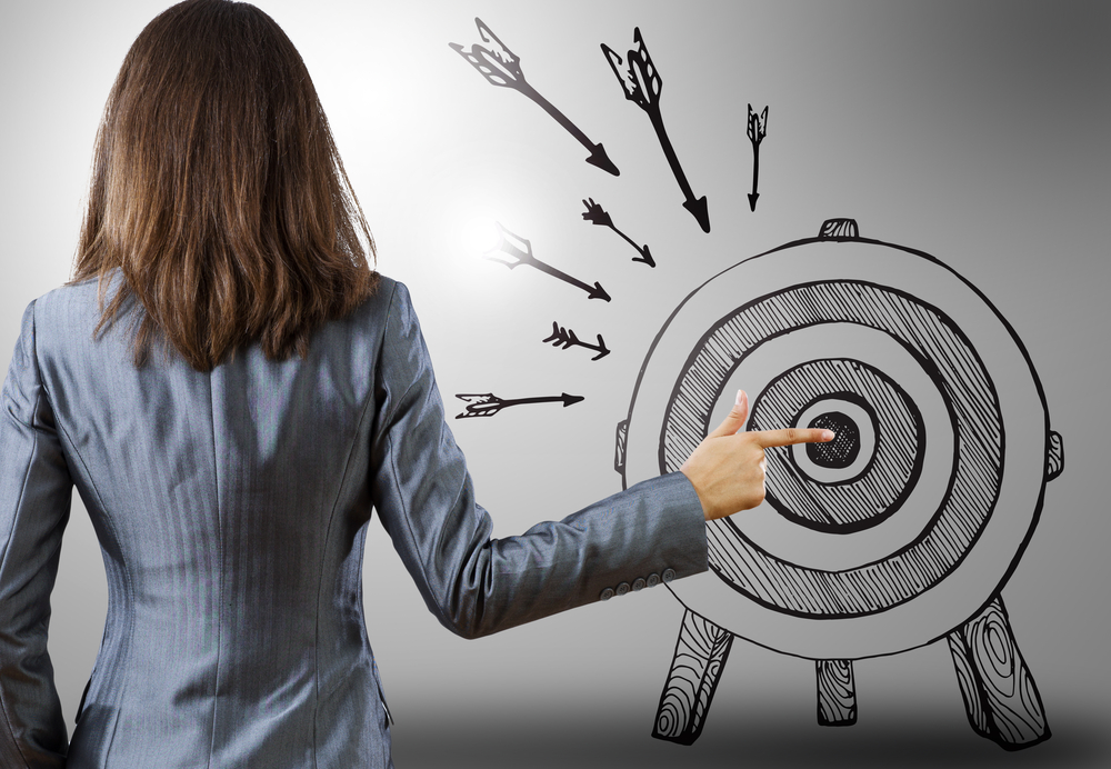 ad fraud - businesswoman pointing at drawn target