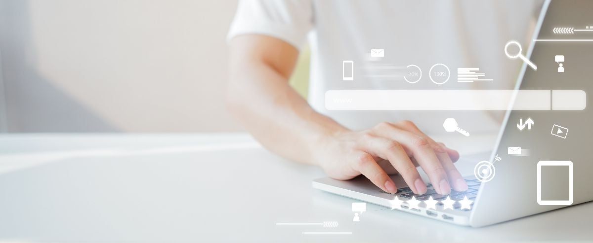 hand typing on laptop with icons overlaying image